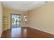 Bedroom with hardwood floors, ceiling fan, built-in bookshelf and access to a screened outdoor pool area at 1348 Reserve Dr, Venice, FL 34285
