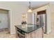 Kitchen featuring center island with microwave and stainless steel refrigerator at 1348 Reserve Dr, Venice, FL 34285