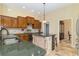 Kitchen with custom cabinets, granite counters, a center island, and stainless steel appliances at 1348 Reserve Dr, Venice, FL 34285