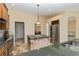 Open-concept kitchen featuring stainless steel appliances and a center island at 1348 Reserve Dr, Venice, FL 34285