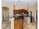 Well-appointed kitchen with custom cabinets, granite counters, tiled backsplash, and modern island at 1348 Reserve Dr, Venice, FL 34285