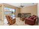 Living area with a fireplace, tile floors, and sliders provides a cozy and bright space at 1348 Reserve Dr, Venice, FL 34285