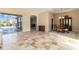 Open-plan living area with dining space, tile flooring, and sliding glass doors at 1348 Reserve Dr, Venice, FL 34285