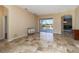Inviting living area with travertine flooring and sliders leading to a screened lanai at 1348 Reserve Dr, Venice, FL 34285