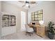 Office space featuring tile floors, a ceiling fan, and large wooden desk and bookshelf at 1348 Reserve Dr, Venice, FL 34285