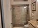 Elegant bathroom boasts a glass-enclosed shower with stone flooring and tiled walls at 201 Auburn Woods Cir, Venice, FL 34292