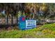 Venice Beach sign with palm trees and lush greenery in the foreground at 201 Auburn Woods Cir, Venice, FL 34292