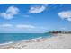 Beautiful view of Venice Beach with clear blue water and sandy shoreline at 201 Auburn Woods Cir, Venice, FL 34292