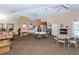 Community clubhouse with tables and chairs, library, kitchen area, and comfortable seating at 201 Auburn Woods Cir, Venice, FL 34292