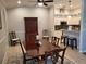 Formal dining room with wood table, fan, and stone backsplash in the nearby kitchen at 201 Auburn Woods Cir, Venice, FL 34292