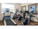 Well-equipped exercise area featuring a treadmill, elliptical, and stationary bikes at 201 Auburn Woods Cir, Venice, FL 34292