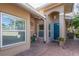Charming front entrance with brick pavers, a teal door, and tasteful landscaping elements at 201 Auburn Woods Cir, Venice, FL 34292