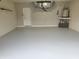 Spacious two-car garage featuring epoxy floor, door to outside, storage, and utility hookups at 201 Auburn Woods Cir, Venice, FL 34292