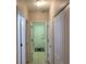 Hallway view leading to the laundry room with neutral walls and tile flooring at 201 Auburn Woods Cir, Venice, FL 34292
