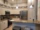 Kitchen features white cabinets, granite countertops, stainless steel appliances, and pendant lighting at 201 Auburn Woods Cir, Venice, FL 34292