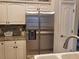 Kitchen with stainless steel refrigerator, granite countertops and white cabinets at 201 Auburn Woods Cir, Venice, FL 34292