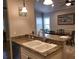 Kitchen with granite countertop, stainless steel faucet, and sink at 201 Auburn Woods Cir, Venice, FL 34292