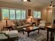 Comfortable living room with wood floors, plantation shutters, and stylish traditional decor at 201 Auburn Woods Cir, Venice, FL 34292