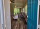 View from the front door to a lovely living room featuring plantation shutters and wood flooring at 201 Auburn Woods Cir, Venice, FL 34292