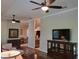 Open living room with views of the dining area and kitchen, featuring wood floors and plenty of natural light at 201 Auburn Woods Cir, Venice, FL 34292