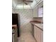 Traditional kitchen with stainless steel appliances and patterned wallpaper at 232 Saint Augustine Ave # 704, Venice, FL 34285