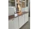 Traditional kitchen features white cabinetry, light countertops, and gold hardware at 232 Saint Augustine Ave # 704, Venice, FL 34285