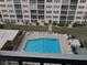 View of community pool and building from screened patio at 232 Saint Augustine Ave # 704, Venice, FL 34285
