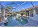 Inviting screened-in pool area with brick-paved deck offers a relaxing outdoor living space at 2899 Ensenada Ln, North Port, FL 34286