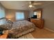 Comfortable bedroom with laminate wood floors, ceiling fan, and natural light at 356 Longwood Dr, Venice, FL 34285