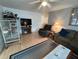 Inviting living room with neutral decor, ceiling fan, and laminate wood flooring at 356 Longwood Dr, Venice, FL 34285