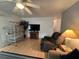 Cozy living room featuring laminate wood flooring, entertainment center, and comfortable seating at 356 Longwood Dr, Venice, FL 34285