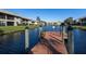 Water view from dock of condo building's backyard with lush landscaping and beautiful blue water at 380 Three Lakes Ln # F, Venice, FL 34285