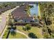 Aerial view of a home with screened-in pool and lake view at 5733 Semolino St, Nokomis, FL 34275
