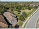 Beautiful aerial view of a well-maintained home and lush green neighborhood park at 5733 Semolino St, Nokomis, FL 34275
