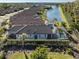 Aerial view of homes near a lake with screened in pools and tile roofs at 5733 Semolino St, Nokomis, FL 34275