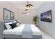 Cozy bedroom with a ceiling fan, modern artwork, and minimalist design at 5733 Semolino St, Nokomis, FL 34275
