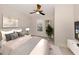 Tranquil bedroom featuring a ceiling fan, plantation shutters, and calming color scheme at 5733 Semolino St, Nokomis, FL 34275