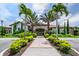 Beautiful clubhouse entrance with lush landscaping and palm trees at 5733 Semolino St, Nokomis, FL 34275