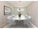 Elegant dining room with modern lighting, stylish chairs, and a chic area rug at 5733 Semolino St, Nokomis, FL 34275
