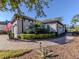 Charming home with manicured landscaping, a brick driveway, and an American flag at 5733 Semolino St, Nokomis, FL 34275