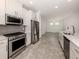 Modern kitchen featuring stainless steel appliances, white cabinetry, and granite counters at 5733 Semolino St, Nokomis, FL 34275