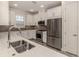 Bright kitchen featuring white cabinets, stainless steel appliances, and a sleek countertop at 5733 Semolino St, Nokomis, FL 34275