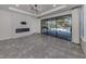 Open living room with tile floors, modern fireplace, and access to the screened patio at 5733 Semolino St, Nokomis, FL 34275