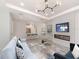 Bright and airy living room with sleek furniture and an electric fireplace, seamlessly flowing into the kitchen at 5733 Semolino St, Nokomis, FL 34275