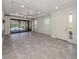 Spacious living room with tiled floors, modern lighting and sliding glass doors to the pool at 5733 Semolino St, Nokomis, FL 34275