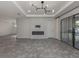 Bright, open-concept living room featuring sleek flooring and a modern fireplace at 5733 Semolino St, Nokomis, FL 34275
