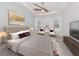 Relaxing main bedroom with a ceiling fan, bay windows, and neutral decor at 5733 Semolino St, Nokomis, FL 34275