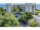 Beautiful, modern condo building with lush landscaping and a circular driveway at 2020 Harbourside Dr # 424, Longboat Key, FL 34228