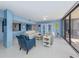 Open living room featuring tile floors, stylish furnishings, and expansive glass doors at 2020 Harbourside Dr # 424, Longboat Key, FL 34228