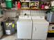 Well-equipped laundry room with washer, dryer, and water heater for modern convenience at 607 Cervina Dr, Venice, FL 34285